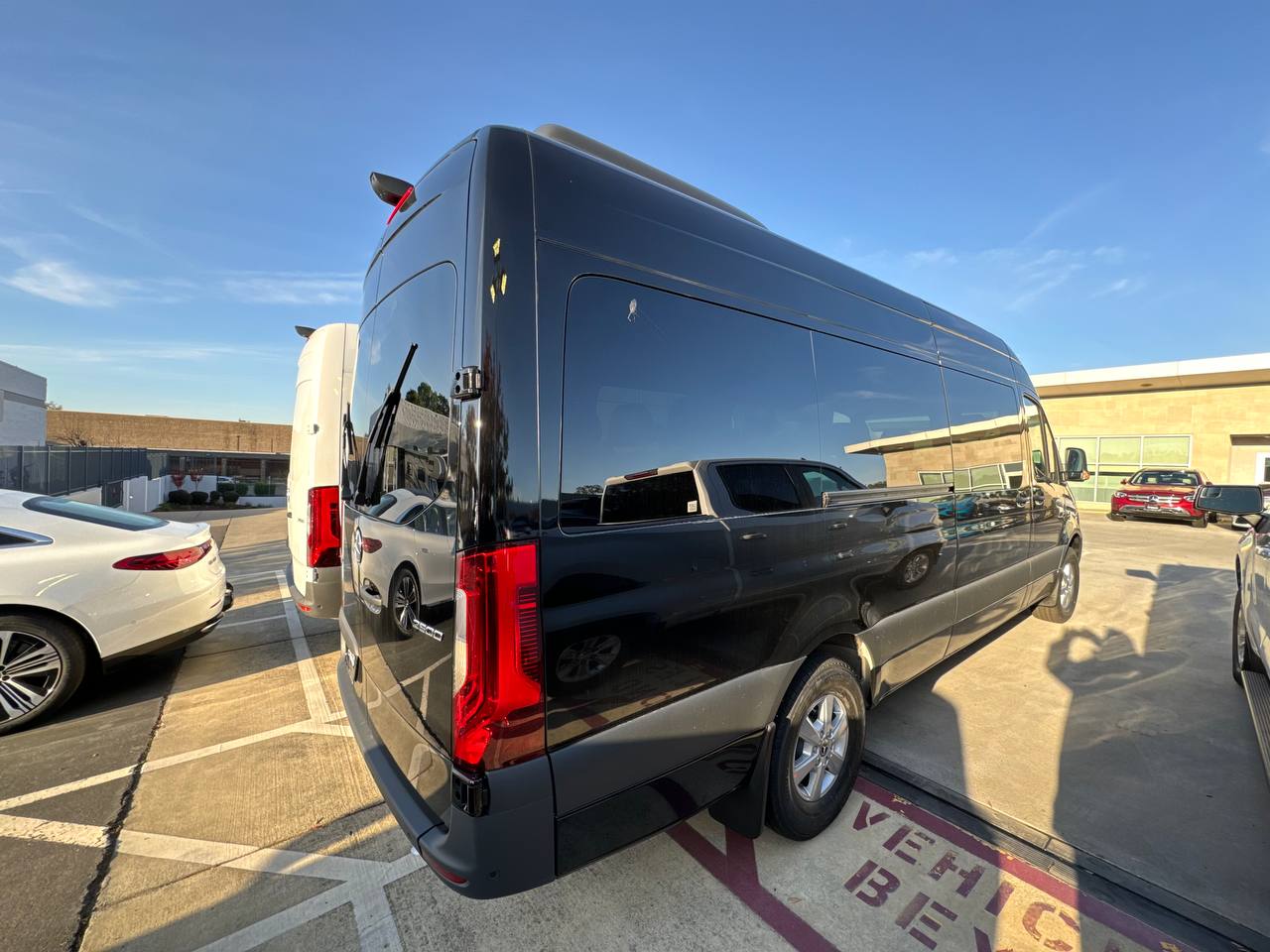 Black Mercedes-Benz Sprinter passenger van with tinted windows available for rental in Chicago