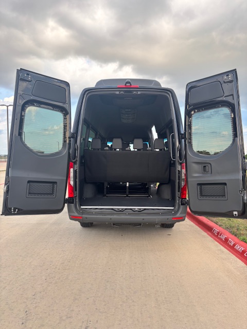 Mercedes-Benz Sprinter passenger van with rear doors open showing seating — Montgomery, AL rental fleet