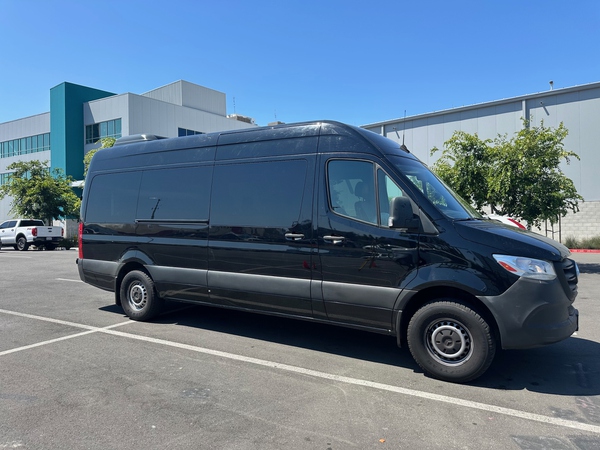 Black Mercedes-Benz Sprinter passenger van side profile — Montgomery, AL van rental fleet near MGM airport