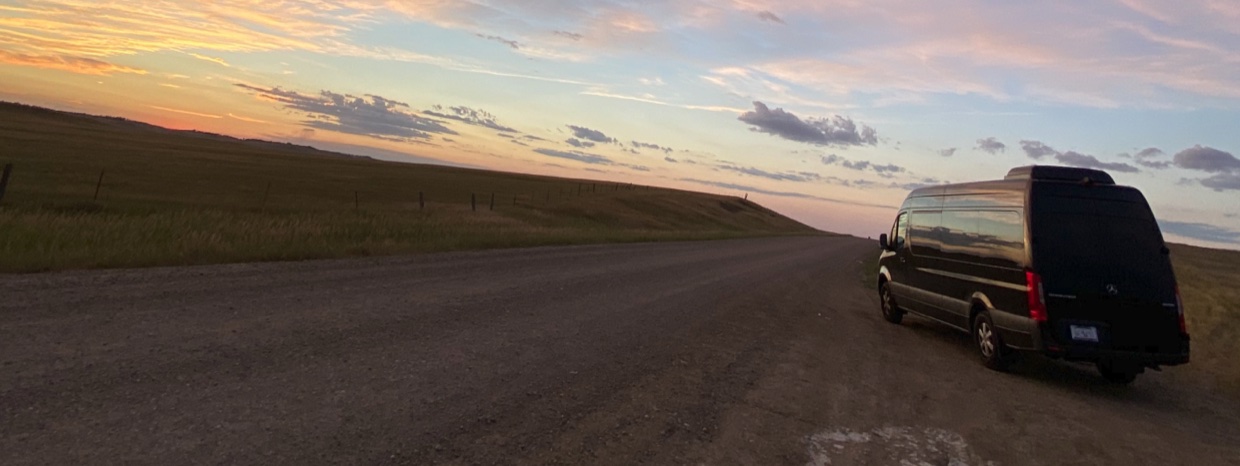 Mercedes-Benz Sprinter van rental on an Inland Empire road near San Bernardino and Ontario at sunset