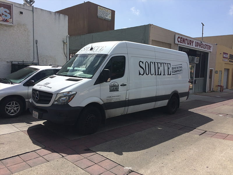 Custom van wrap design showcasing creative vehicle graphics on a sprinter van